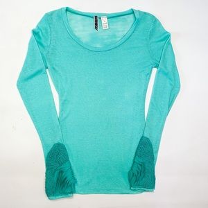Light teal long sleeve waffle knit top, with detailed sleeves.